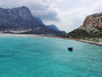 Scenic view of sea and mountains against sky