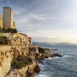 Scenic view of sea and buildings against sky