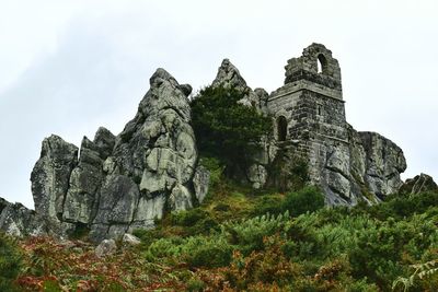 Low angle view of rock formations against sky