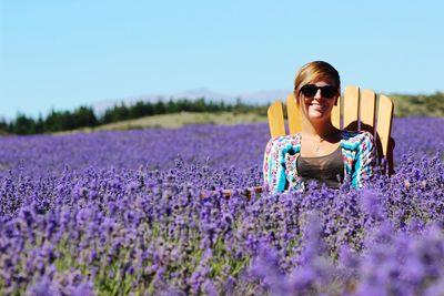 Portrait of woman sitting in lavender field