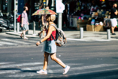 Full length of woman walking on road