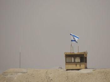 Lifeguard hut on beach against clear sky