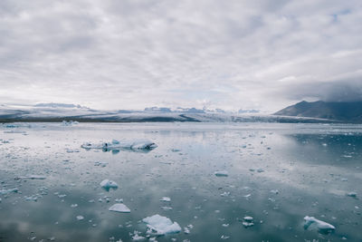 Scenic view of frozen lake against sky