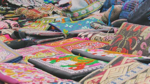 Close-up of embroidered bags displayed for sale