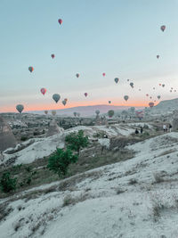 Hot air balloons against sky during sunset