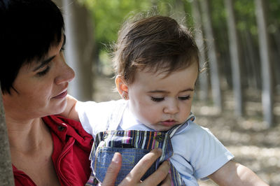 Close-up of grandmother looking at granddaughter while standing outdoors