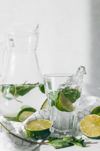 Glass of fruit and drink on table