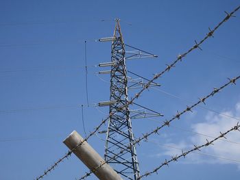 Low angle view of electricity pylon against sky