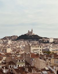 Buildings in city against sky