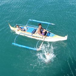 High angle view of man and boy in boat