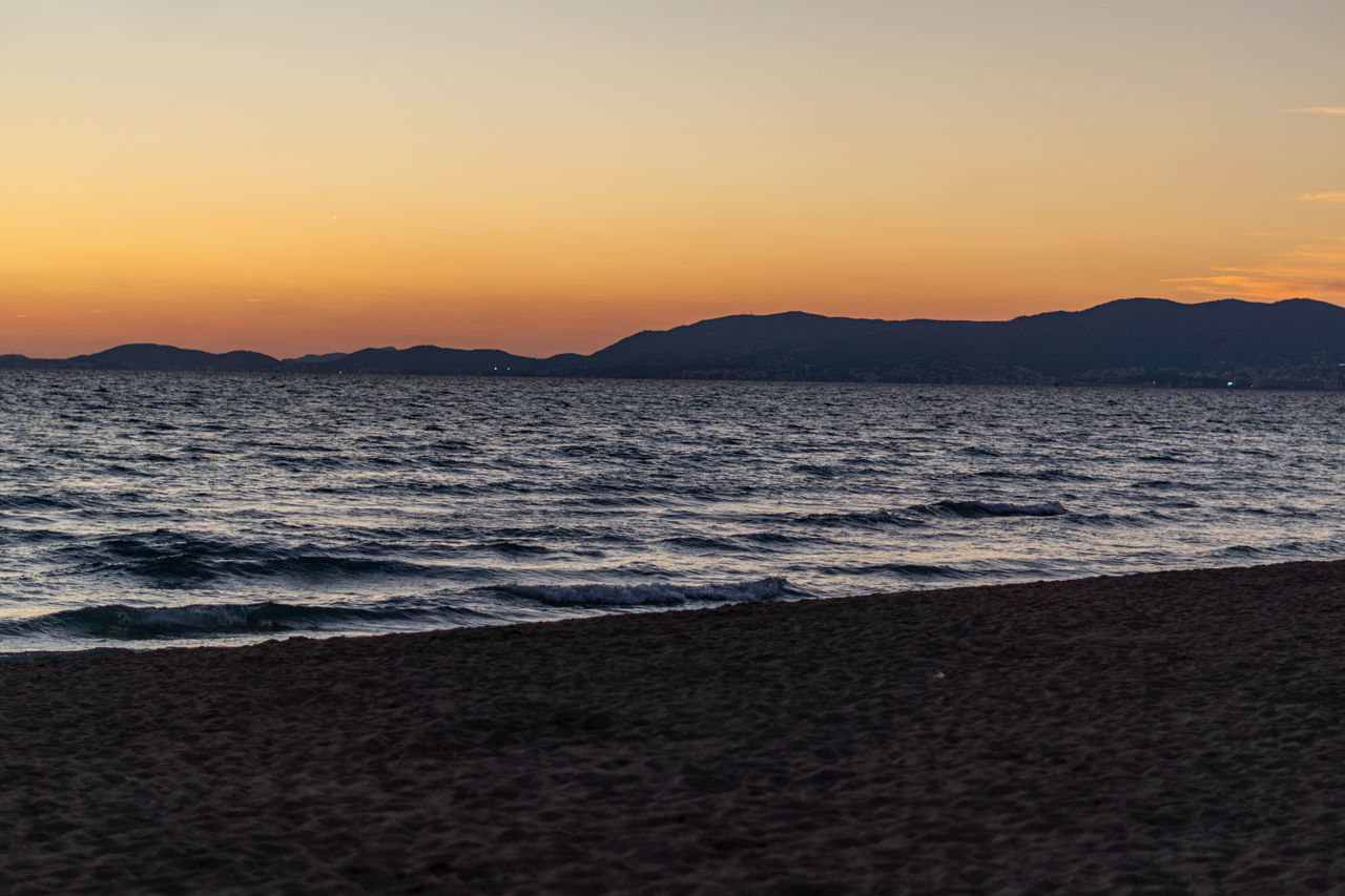 SCENIC VIEW OF BEACH DURING SUNSET