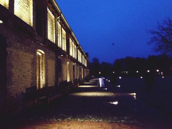 Illuminated walkway at night