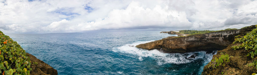 Scenic view of sea against cloudy sky