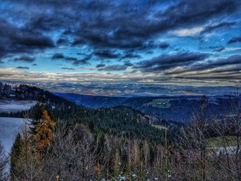 Scenic view of landscape against sky during winter