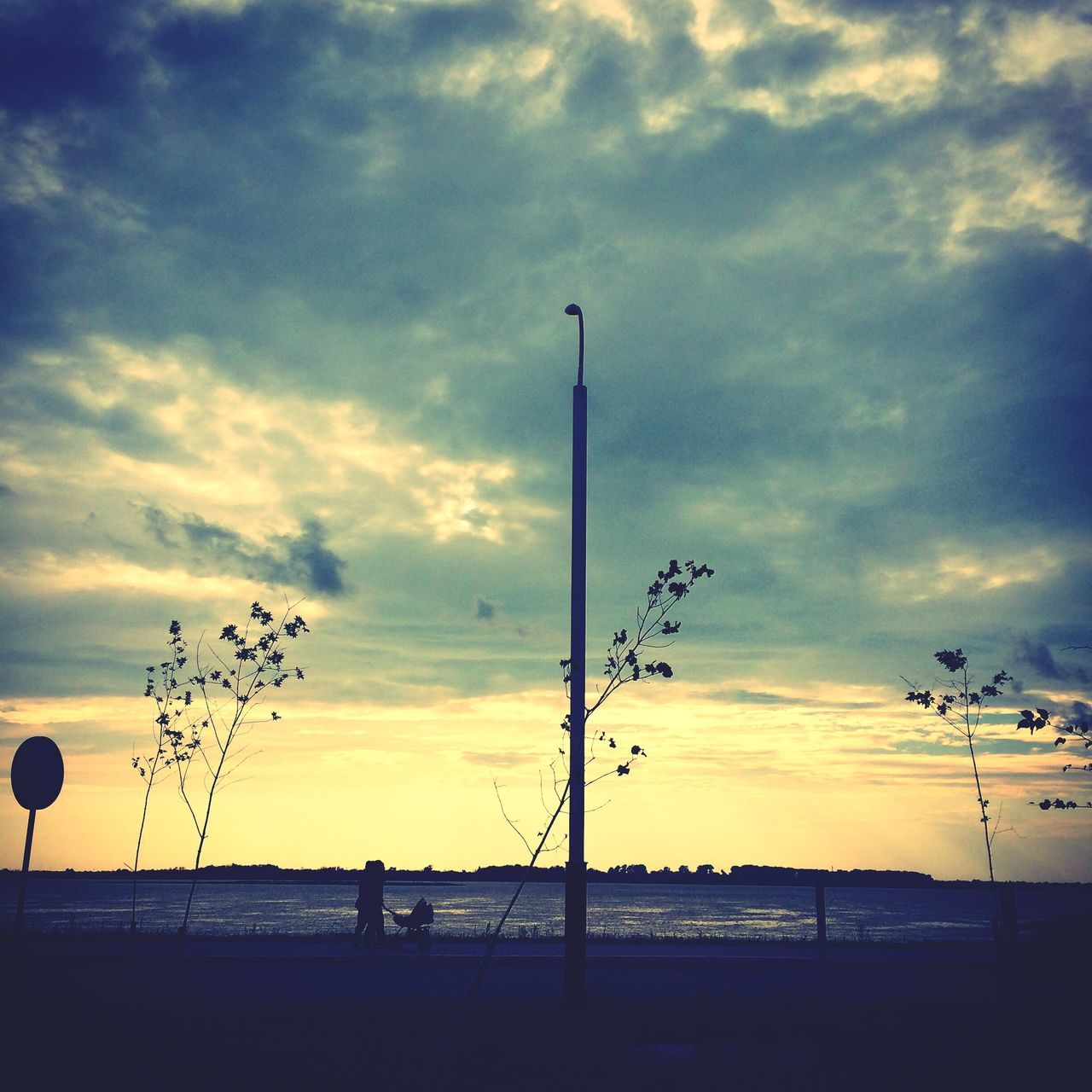 sunset, sky, silhouette, cloud - sky, street light, scenics, beauty in nature, cloud, tranquility, tranquil scene, cloudy, nature, orange color, beach, low angle view, idyllic, dramatic sky, sea, horizon over water, tree