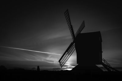 Low angle view of traditional windmill against sky