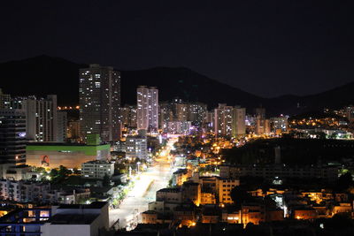 High angle view of illuminated buildings against sky at night