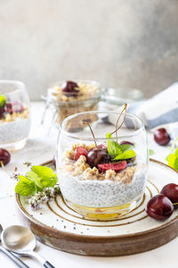 Healthy menu concept. home made granola breakfast. glass of parfait made of granola, berries cherry.