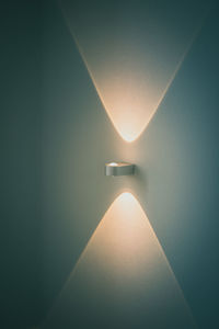 Illuminated light bulbs on wall in building