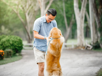 Man playing with dog at park