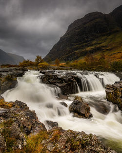 Powerful scottish waterfall under a rain filled sky