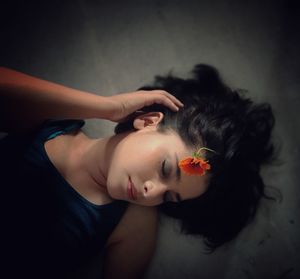 Portrait of woman lying down on floor