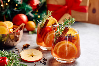 Mulled wine or christmas sangria with aromatic spices, apple, cherry and citrus fruits.