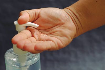 Close-up of hand holding bottle