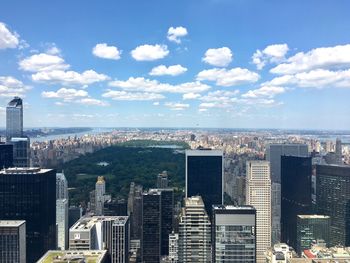 Aerial view of buildings in city against sky
