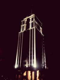 Low angle view of illuminated building against sky at night