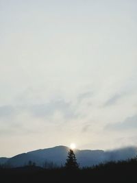 Scenic view of silhouette mountains against sky at sunset