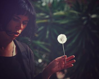 Woman holding dandelion