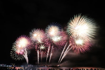 Low angle view of firework display at night