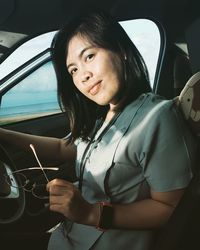 Portrait of woman sitting in car