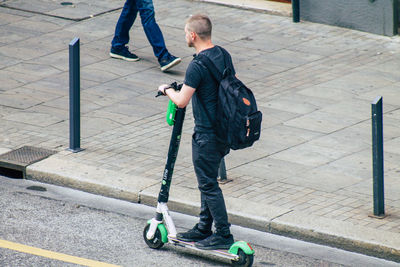 Low section of men walking on sidewalk