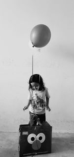 Rear view of a girl holding balloons