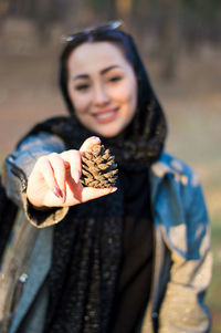 Portrait of smiling young woman holding ice cream cone