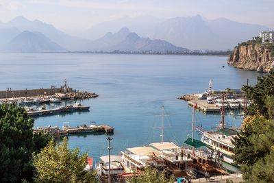 Antalya, turkey - november 15, 2022. scenic harbor view with boats with mountains and clear blue sea