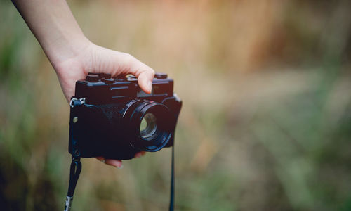 Midsection of man photographing camera