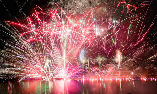 Low angle view of firework display at night