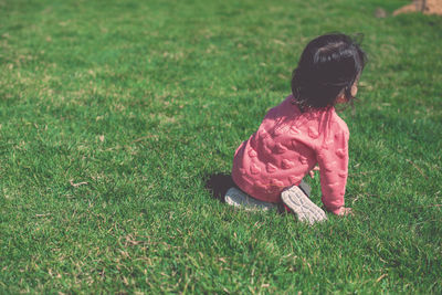 Rear view of a girl on field