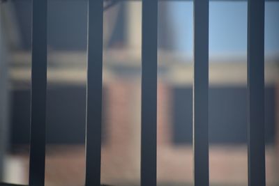 Close-up of metal fence against wall