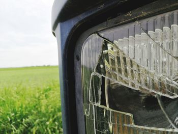 Close-up of car window on field