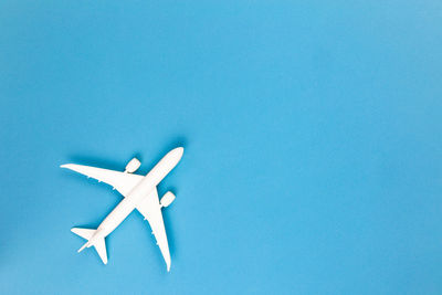 Close-up of airplane against blue background