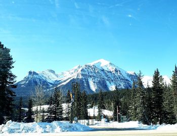 Snow covered landscape against sky