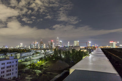 Illuminated buildings in city against sky at night