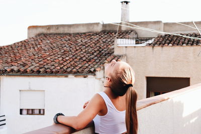 Full length of woman on roof of building