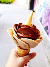 Close-up of hand holding ice cream