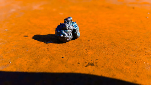 High angle view of metal on orange footpath