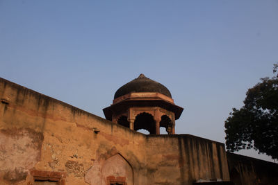 Low angle view of fort against clear blue sky